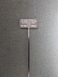 brown recycled water sign used to identify landscape areas using recycled water in Irvine, California.