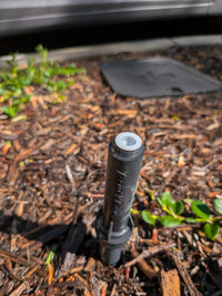 Flow restriction screen for landscape irrigation nozzle