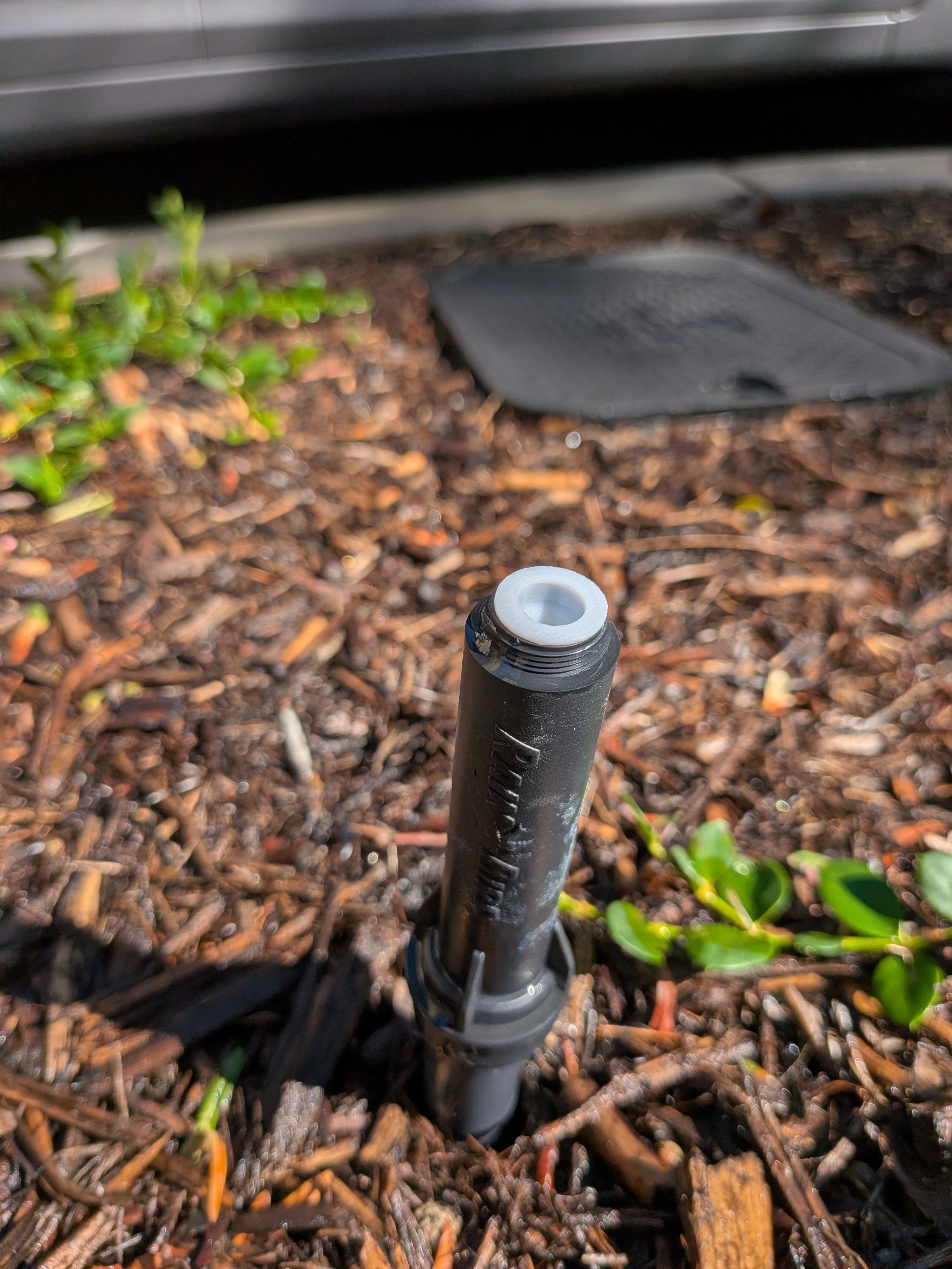 Flow restriction screen for landscape irrigation nozzle